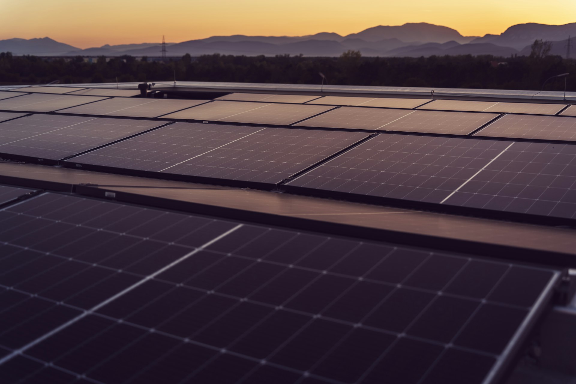 a large solar panel with mountains in the background